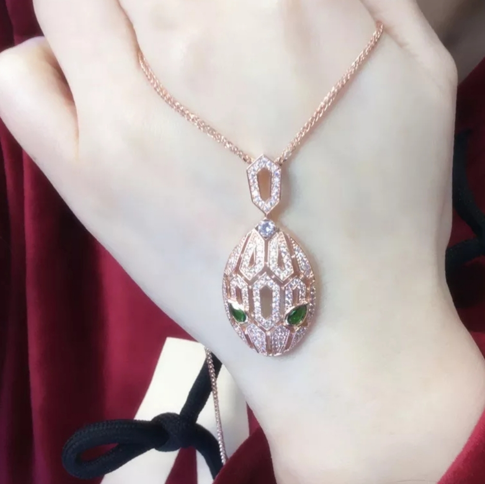 Gold rose snake pendant with chain.